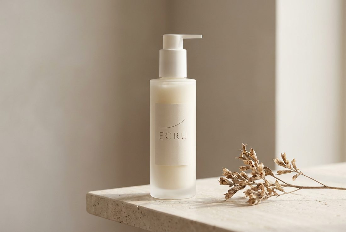 ECRU cleanser bottle shown clearly against a pale stone setting
